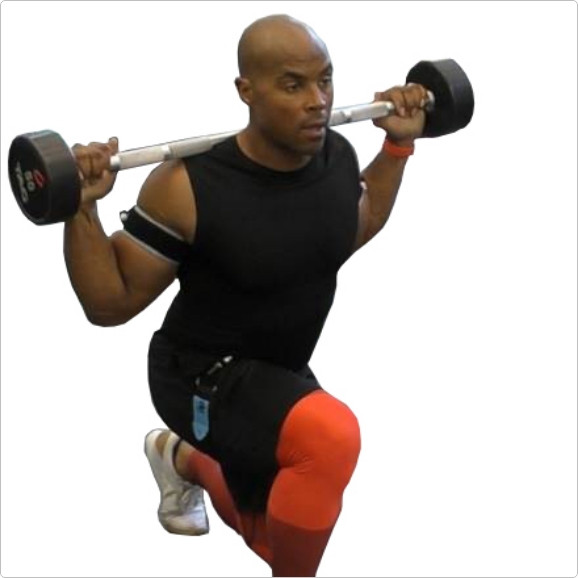 Man squating with blood flow restriction cuffs and bands