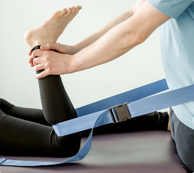 Physical Therapist assisting a client with a stretch